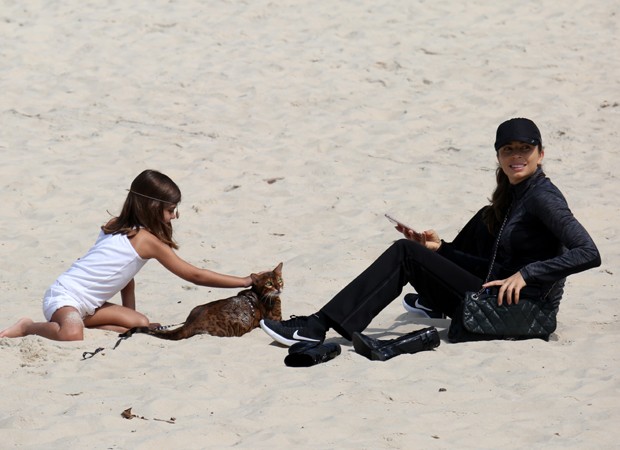 Grazzi e sua filha brincando na praia com seu gato Bengal